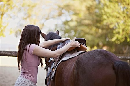 Young Woman Saddles A Horse, Baranja, Croatia, Europe Stock Photo - Premium Royalty-Free, Code: 6115-06733057