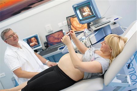 sonogram - Pregnant Woman Holding Sonogram Stock Photo - Premium Royalty-Free, Code: 6115-06733277