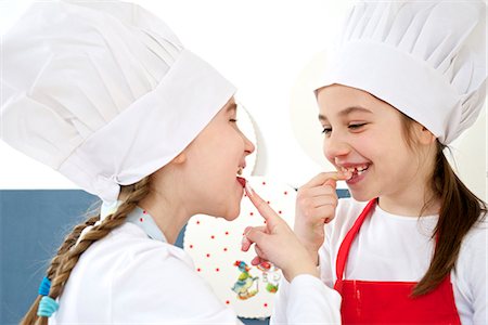 simsearch:649-05520883,k - Two little girls with chef's hat kidding around, Munich, Bavaria, Germany Stock Photo - Premium Royalty-Free, Code: 6115-06966916