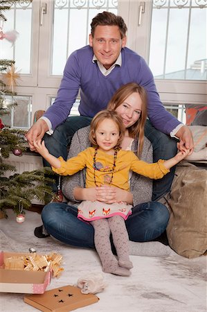 simsearch:6115-06778498,k - Parents with daughter alongside Christmas tree, Munich, Bavaria, Germany Stock Photo - Premium Royalty-Free, Code: 6115-06967055
