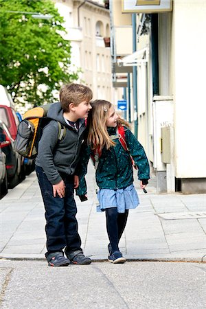 education and back to school - Two children walking to school, keeping an eye on the traffic, Munich, Bavaria, Germany Stock Photo - Premium Royalty-Free, Code: 6115-07109649