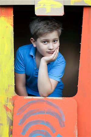 playhouse - Boy in cardboard playhouse, portrait, Munich, Bavaria, Germany Stock Photo - Premium Royalty-Free, Code: 6115-07109686