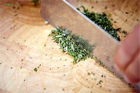 simsearch:6115-07282765,k - Person Cutting Fresh Herbs Stock Photo - Premium Royalty-Free, Code: 6115-07282759