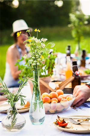 Friends barbecuing on the riverside, picnic table in foreground, Bavaria, Germany Stock Photo - Premium Royalty-Free, Code: 6115-07282769