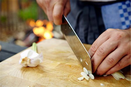 Person Cutting Garlic Stock Photo - Premium Royalty-Free, Code: 6115-07282738