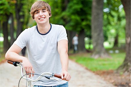 Young man with bicycle in a park, Osijek, Croatia Stock Photo - Premium Royalty-Free, Code: 6115-07282901