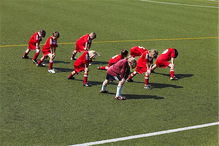 preteen exercising stretching - Group of boys at soccer training, stretching, Munich, Bavaria, Germany Stock Photo - Premium Royalty-Free, Code: 6115-07539648