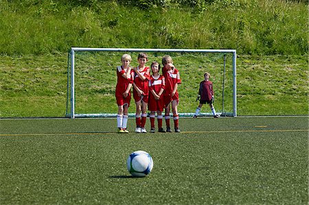 sports team - Boys at soccer training, ball in foreground, Munich, Bavaria, Germany Stock Photo - Premium Royalty-Free, Code: 6115-07539652