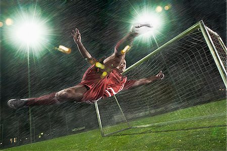 soccer jersey - Soccer playing performing a bicycle kick in front of goal Stock Photo - Premium Royalty-Free, Code: 6115-07539792