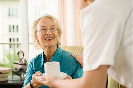 Senior woman receiving a cup of tea in nursing home, Bavaria, Germany Stock Photo - Premium Royalty-Free, Code: 6115-07539796