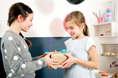 simsearch:6115-06778498,k - Girl on birthday party receiving present, Munich, Bavaria, Germany Stock Photo - Premium Royalty-Free, Code: 6115-08066230