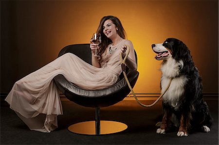 simsearch:400-04398921,k - Woman drinking a glass of wine alongside huge dog Stock Photo - Premium Royalty-Free, Code: 6115-08066534