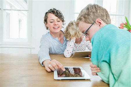 simsearch:6113-07730567,k - Mother and children playing with digital tablet Stock Photo - Premium Royalty-Free, Code: 6115-08149254