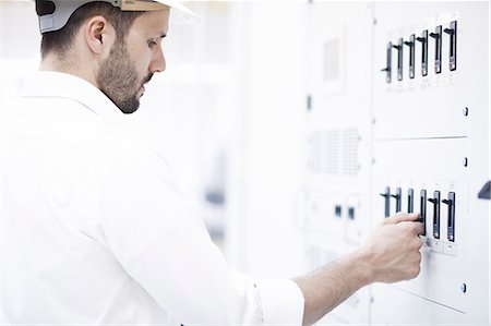 Engineer checking switch in electricity substation Stock Photo - Premium Royalty-Free, Code: 6115-08149398