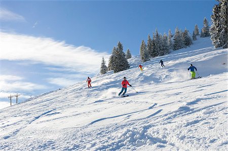 Ski holiday, Group of skiers carving downhill, Sudelfeld, Bavaria, Germany Stock Photo - Premium Royalty-Free, Code: 6115-08149319