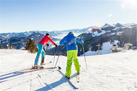 Ski holiday, Skiers overlooking mountain scenery, Sudelfeld, Bavaria, Germany Stock Photo - Premium Royalty-Free, Code: 6115-08149332