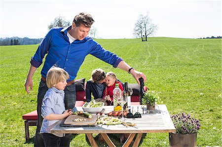 dad - Family having barbecue in the meadow Photographie de stock - Premium Libres de Droits, Code: 6115-08149435