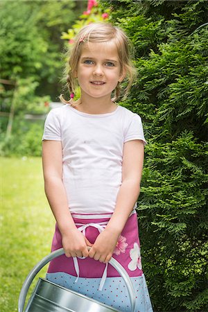 simsearch:6115-07539732,k - Little girl gardening, holding a watering can Stock Photo - Premium Royalty-Free, Code: 6115-08100447