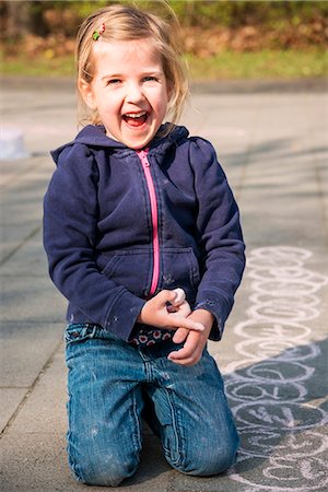 Blonde girl drawing with chalk on sidewalk, Munich, Bavaria, Germany Stock Photo - Premium Royalty-Free, Code: 6115-08100483