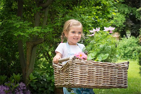 simsearch:6115-07539732,k - Girl gardening, carrying flowers in basket Stock Photo - Premium Royalty-Free, Code: 6115-08100427
