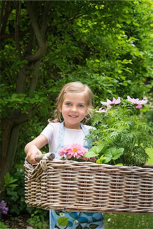 simsearch:6115-07539732,k - Girl gardening, carrying flowers in basket Stock Photo - Premium Royalty-Free, Code: 6115-08100426