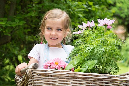 simsearch:6115-07539732,k - Girl gardening, carrying flowers in basket Stock Photo - Premium Royalty-Free, Code: 6115-08100428