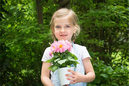 simsearch:6115-07539732,k - Girl gardening, holding pot with flowers Stock Photo - Premium Royalty-Free, Code: 6115-08100429
