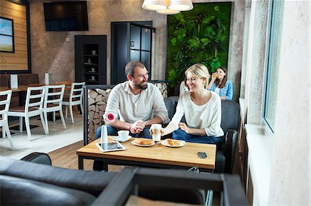 simsearch:6115-07282765,k - Couple flirting in a cafe, people in background Stock Photo - Premium Royalty-Free, Code: 6115-08100506