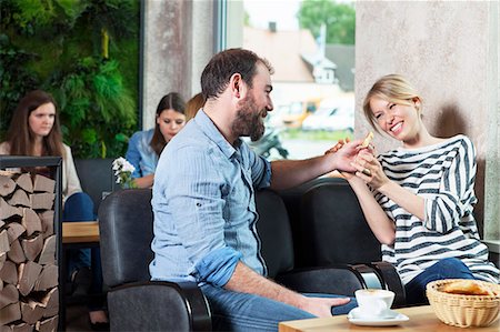 simsearch:6115-07282765,k - Couple flirting in a cafe, people in background Stock Photo - Premium Royalty-Free, Code: 6115-08100508