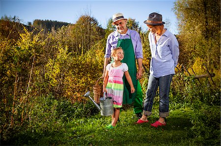 Grandparents with granddaughter gardening, Munich, Bavaria, Germany Stock Photo - Premium Royalty-Free, Code: 6115-08100655