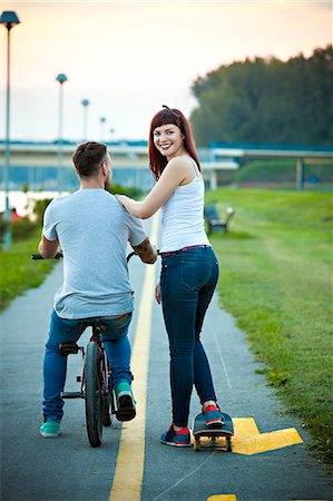 Young couple with BMX bicycle and skateboard outdoors Stock Photo - Premium Royalty-Free, Code: 6115-08100734