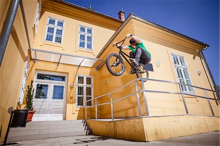 simsearch:6115-06778762,k - BMX biker jumping over a railing Photographie de stock - Premium Libres de Droits, Code: 6115-08100900