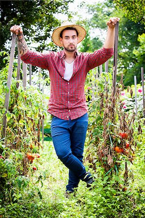 simsearch:6115-06732928,k - Portrait of young man in vegetable garden Stock Photo - Premium Royalty-Free, Code: 6115-08101177