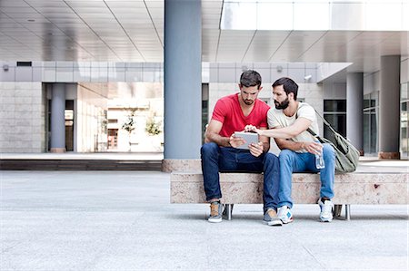 student (male) - Two male university students using digital tablet on campus Stock Photo - Premium Royalty-Free, Code: 6115-08101121