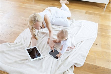 simsearch:6115-07539732,k - Mother and baby playing with digital tablet Stock Photo - Premium Royalty-Free, Code: 6115-08104897