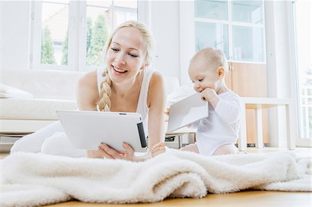 simsearch:6115-07539732,k - Mother with digital tablet alongside baby Stock Photo - Premium Royalty-Free, Code: 6115-08104895