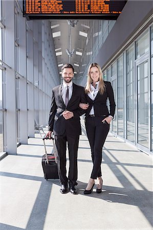Business partners arm in arm in airport Stock Photo - Premium Royalty-Free, Code: 6115-08104943