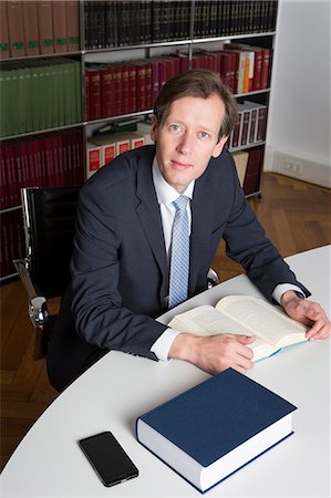 Lawyer with book in office Stock Photo - Premium Royalty-Free, Code: 6115-08105151