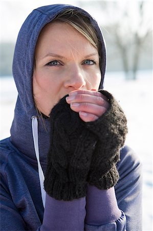 Woman in hooded shirt feeling cold Stock Photo - Premium Royalty-Free, Code: 6115-08105188