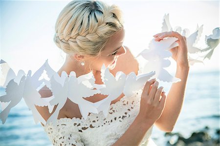 silhouettes cheerful people - Bride playing with white paper cut out outdoors Stock Photo - Premium Royalty-Free, Code: 6115-08239479