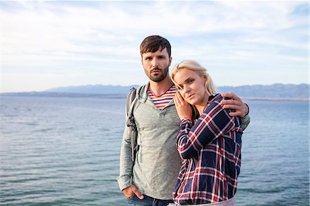 summer hike - Portrait of young couple on water's edge Stock Photo - Premium Royalty-Free, Code: 6115-08239611