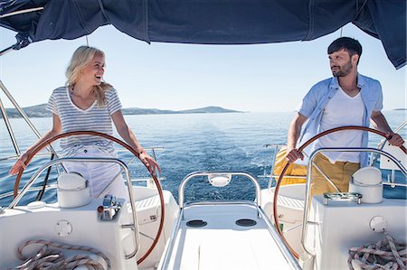 simsearch:6115-07539685,k - Young couple steering together on sailboat, Adriatic Sea Stock Photo - Premium Royalty-Free, Code: 6115-08239703