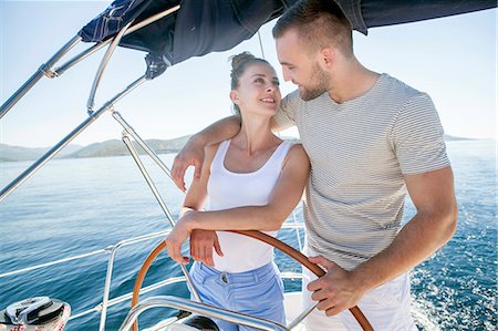 simsearch:6115-07539685,k - Young couple steering together on sailboat, Adriatic Sea Stock Photo - Premium Royalty-Free, Code: 6115-08239707