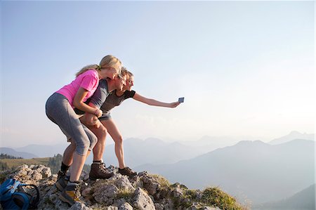 Group of friends taking picture on mountain peak Stock Photo - Premium Royalty-Free, Code: 6115-08239870