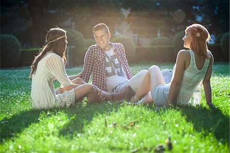 Young people in hippie style fashion sitting in the meadow Stock Photo - Premium Royalty-Free, Code: 6115-08239910