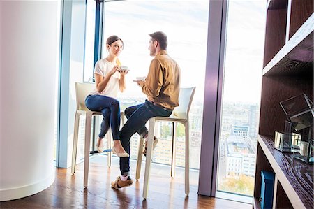 Couple in apartment having a coffee break Stock Photo - Premium Royalty-Free, Code: 6115-08416173