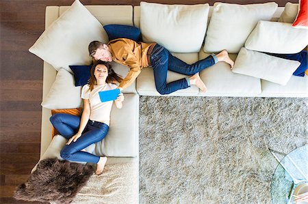 Couple relaxing in modern apartment Stock Photo - Premium Royalty-Free, Code: 6115-08416174