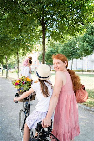 simsearch:400-06412547,k - Mother and daughter riding bicycle Stock Photo - Premium Royalty-Free, Code: 6115-08416139