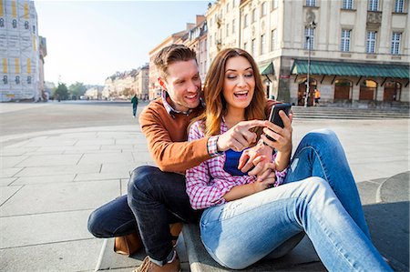 Mid adult couple on a city break using smart phone Stock Photo - Premium Royalty-Free, Code: 6115-08416248