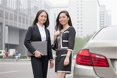 Two Businesswomen Standing On Road Stock Photo - Premium Royalty-Free, Code: 6116-06938889